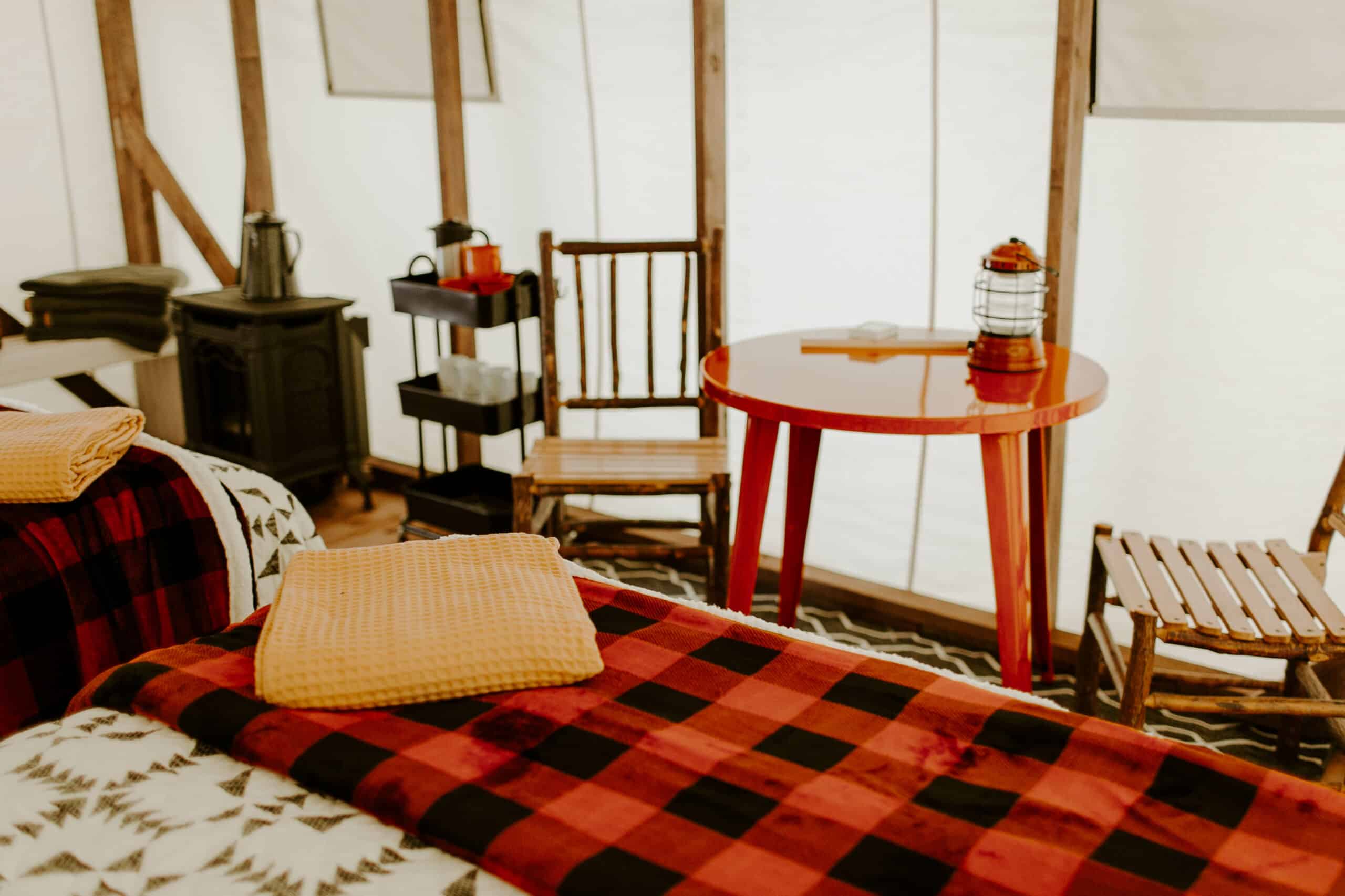 Cozy glamping tent interior with cabin decor.