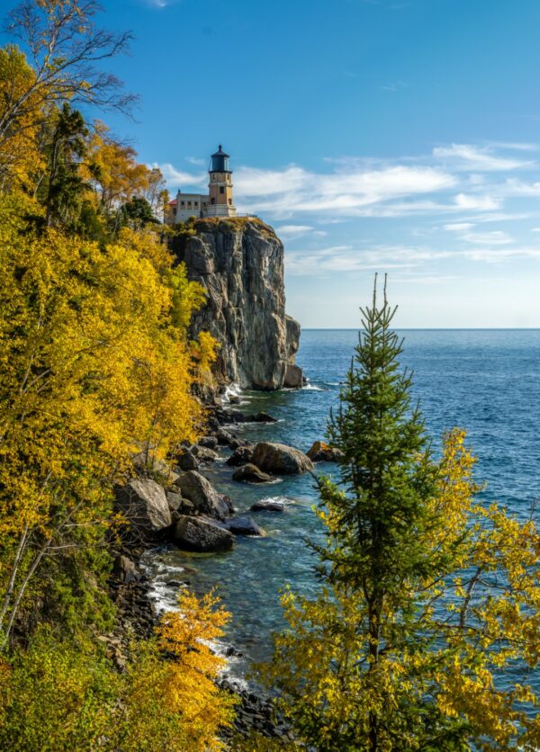 Autumn colors at coastal lighthouse on cliff