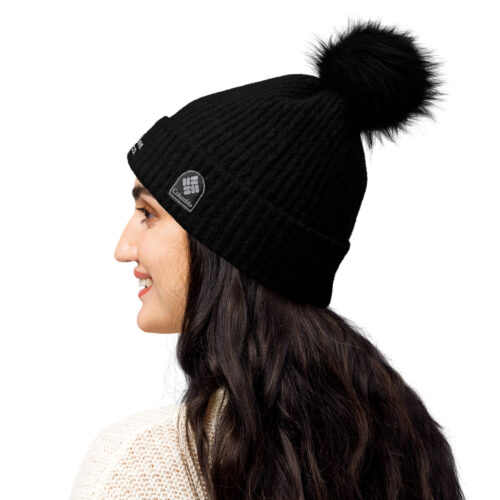 Woman wearing black beanie with pom-pom