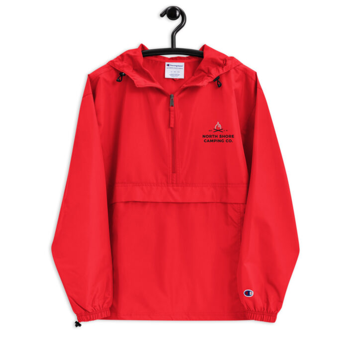 Red pullover windbreaker jacket on hanger, logo visible.