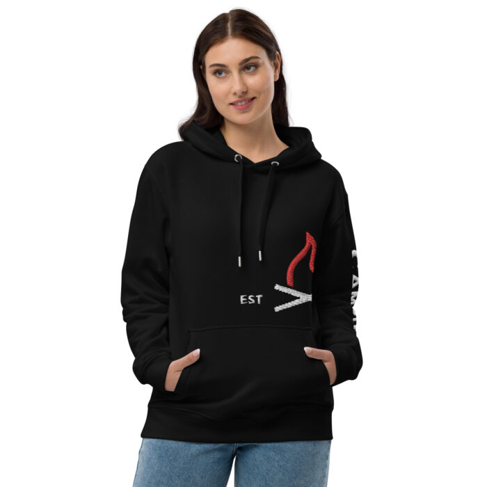 Woman modeling black hoodie with embroidered design.