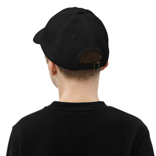 Back view of person in black cap and sweater.