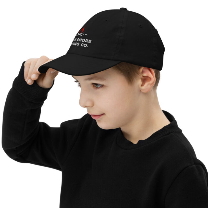 Child wearing black cap and sweater.