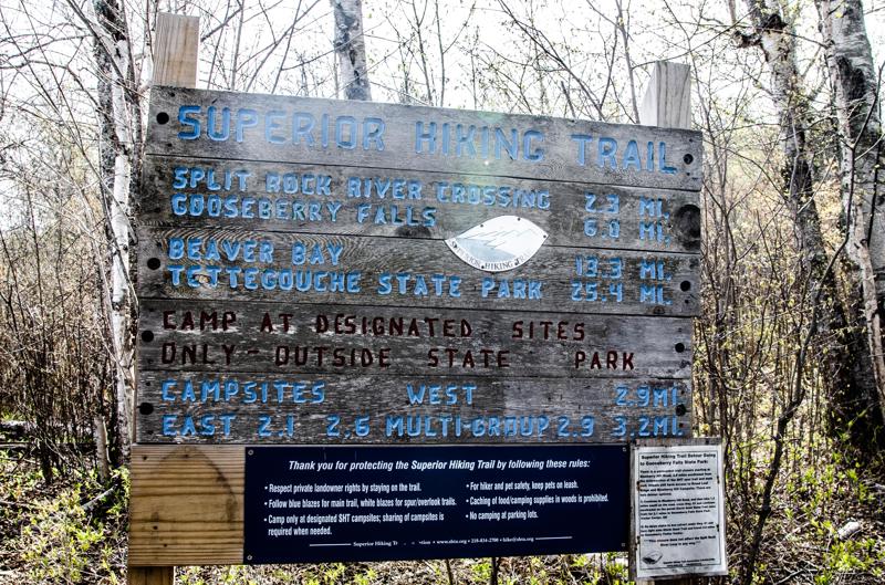 Superior Hiking Trail sign with destinations and distances.