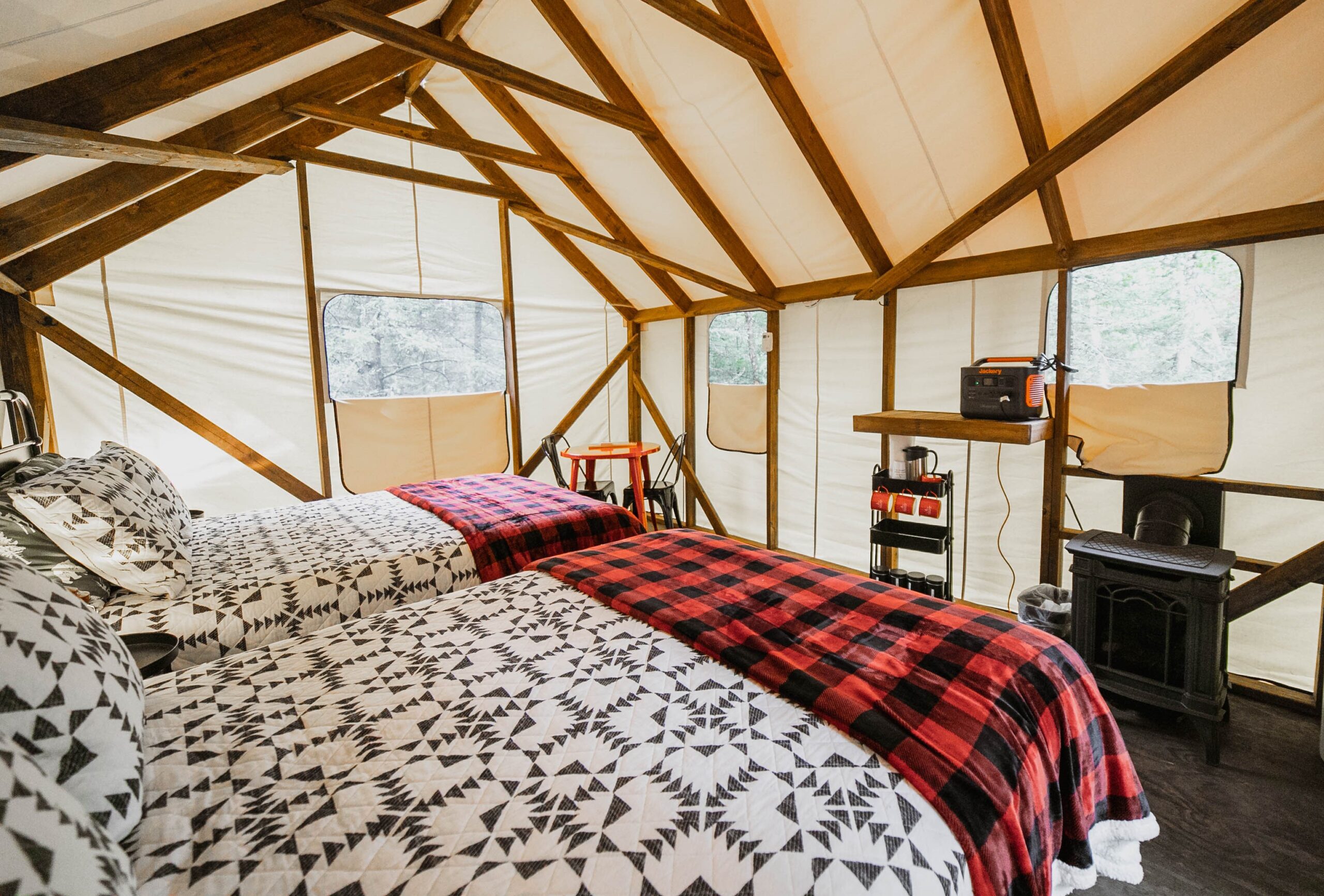 Cozy glamping tent with twin beds and patterns.