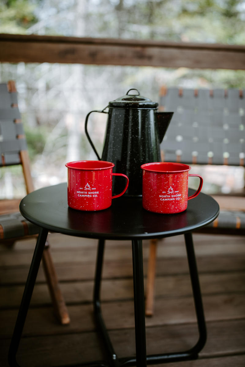 Red mugs and coffee pot on patio table