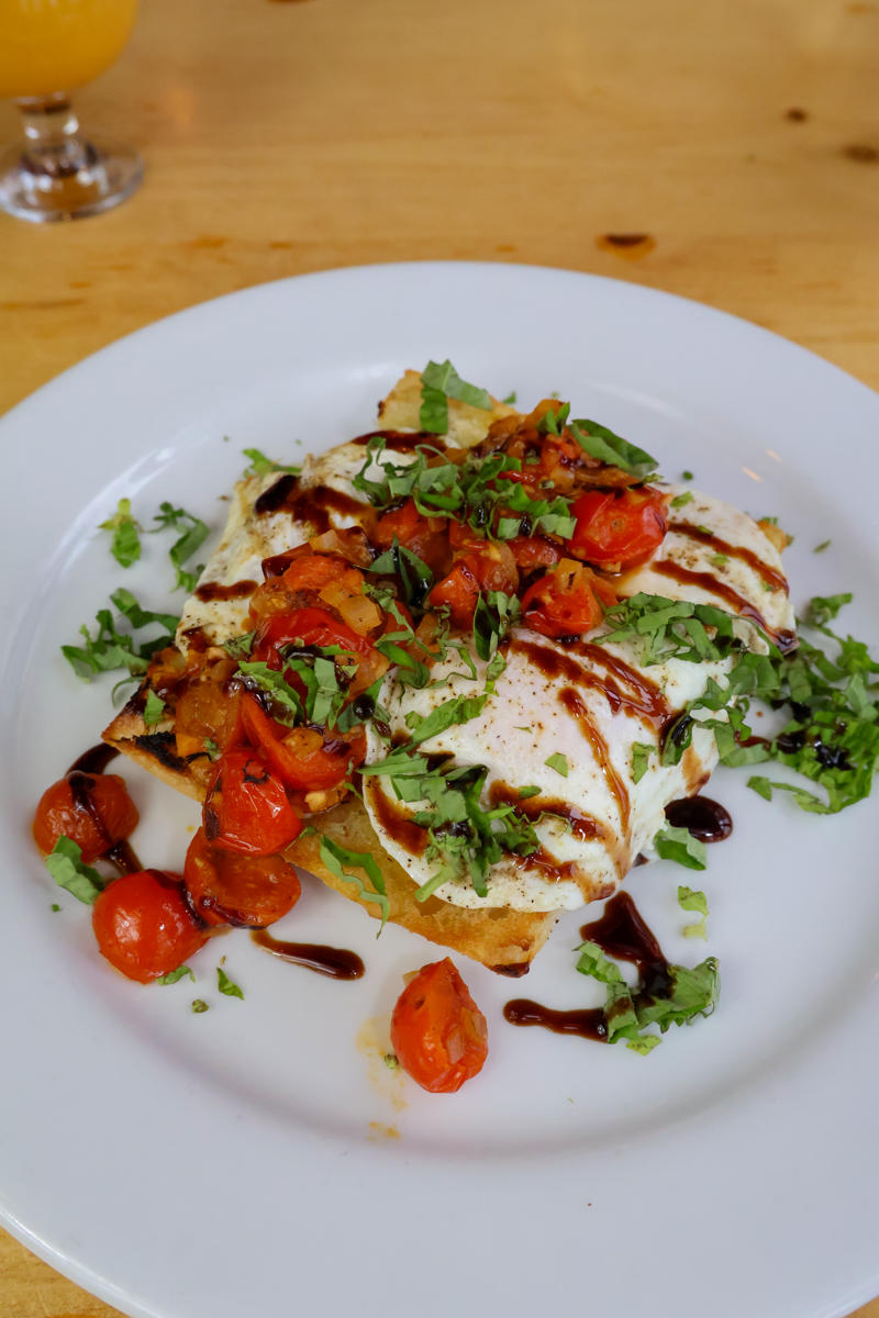 Caprese toast with tomatoes and balsamic glaze.