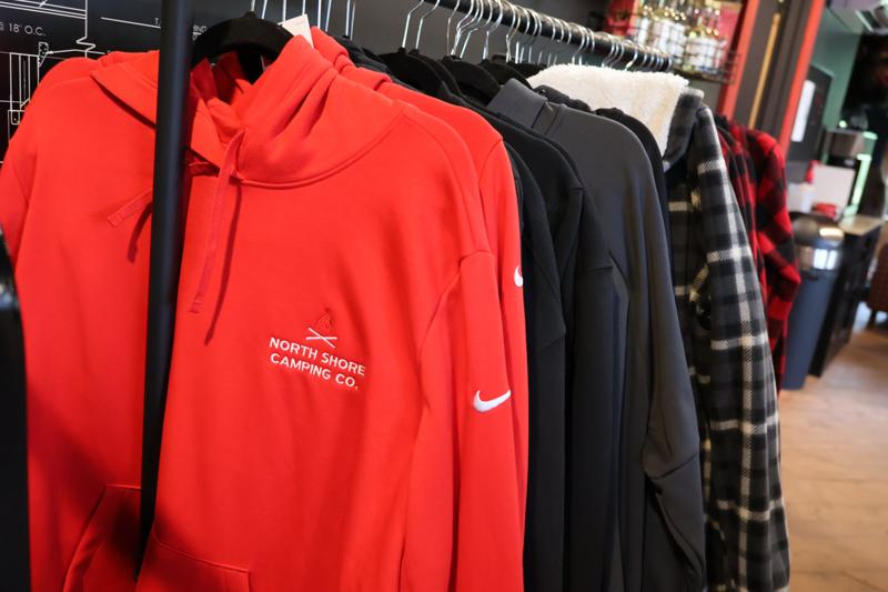 Various hoodies hanging on clothing rack