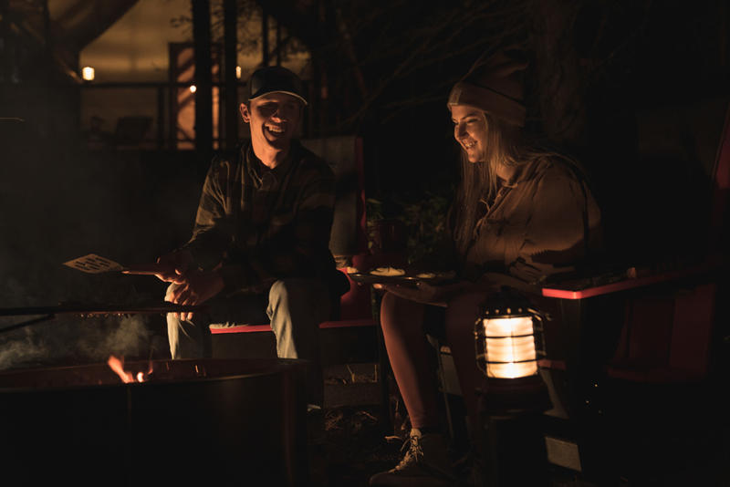 Friends enjoying campfire at night