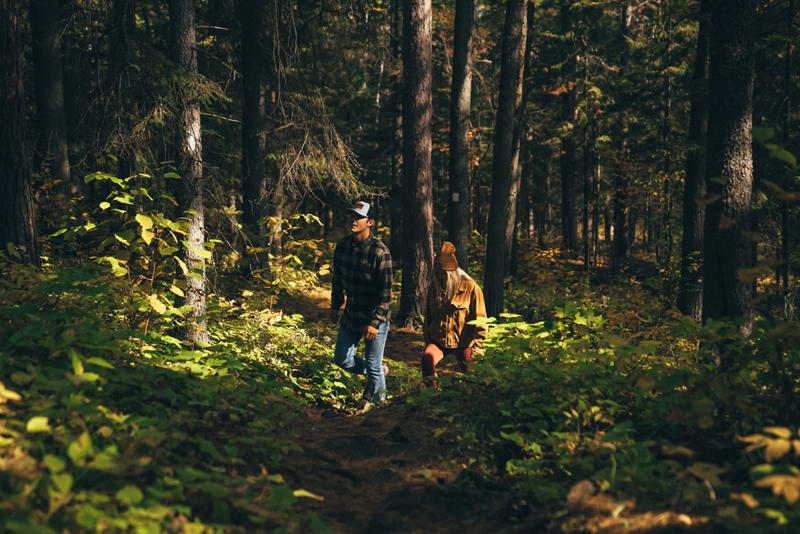 People hiking through dense forest