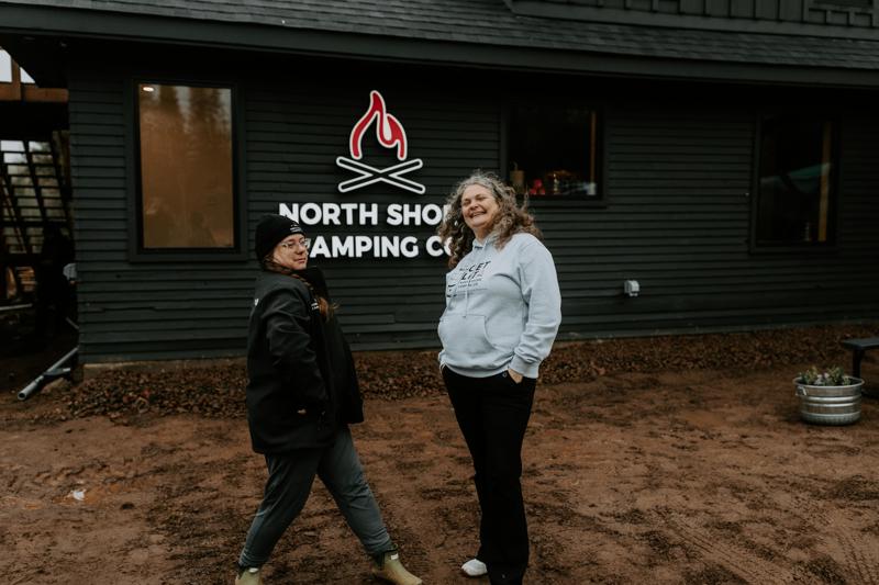 Two people smiling outside North Shore Camping Co.
