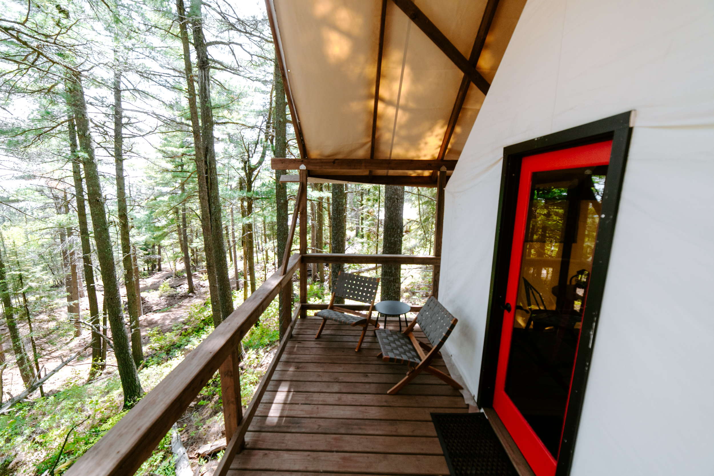 Forest cabin porch with chairs and table