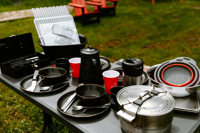 cp nscc 0524 98 (1) Outdoor table set with various camping dishes.