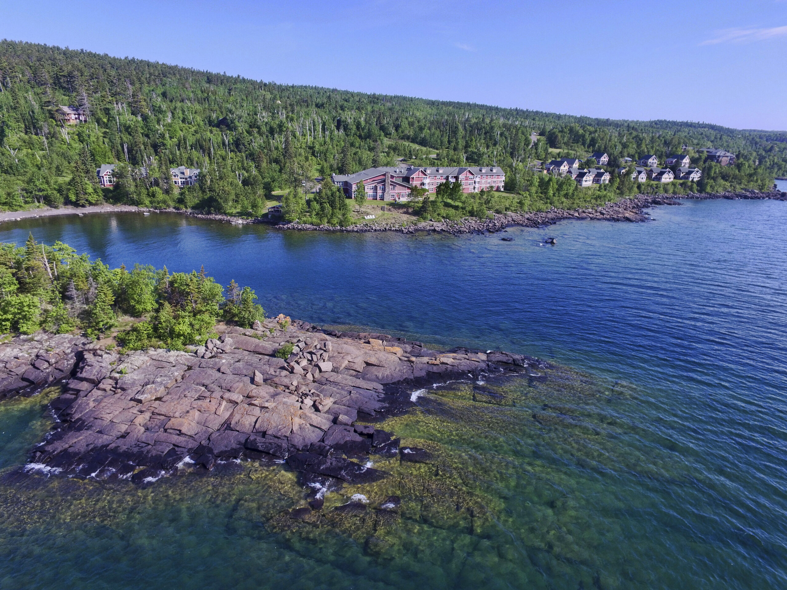 dcim100mediadji 0050.jpg Scenic lakeside view with forest and cabins.
