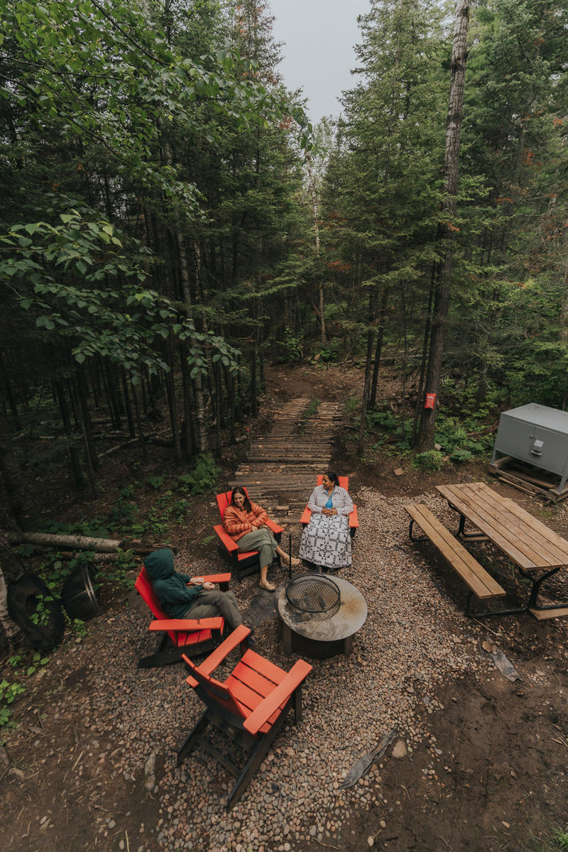 dsc02486 (1) Group relaxing by forest fire pit area.