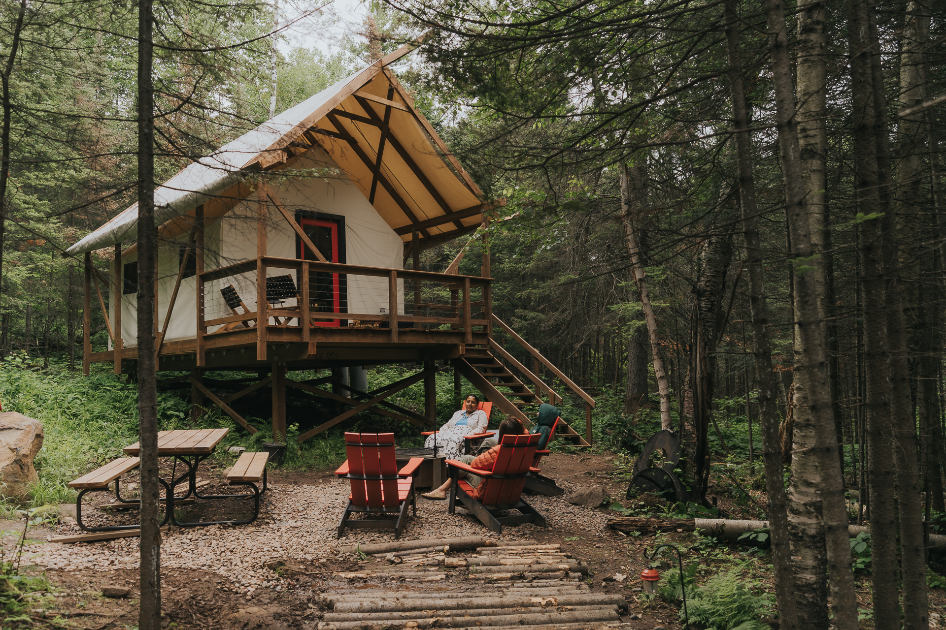 Cozy cabin in forest with picnic area.