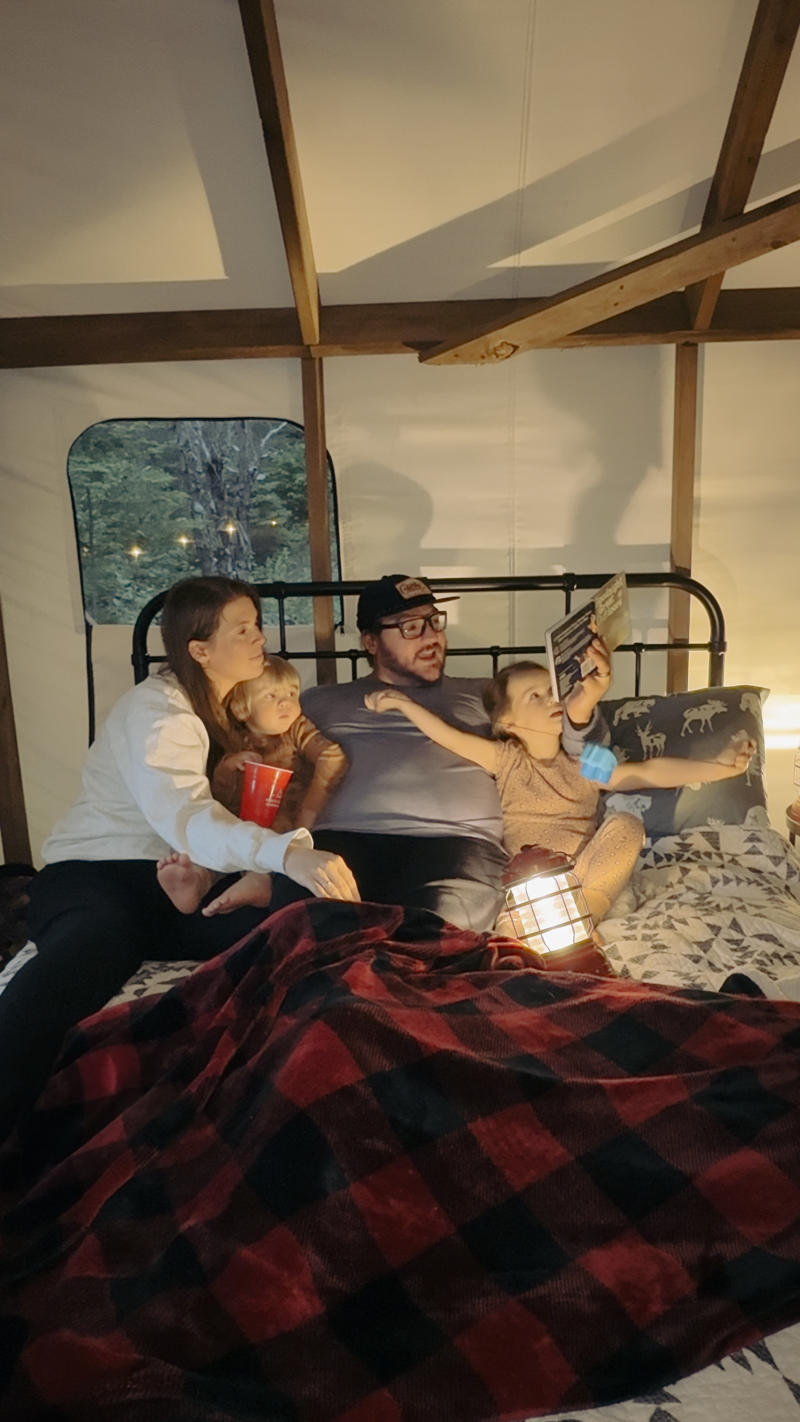 familyreadingintent (2) Family reading bedtime story in cozy tent.