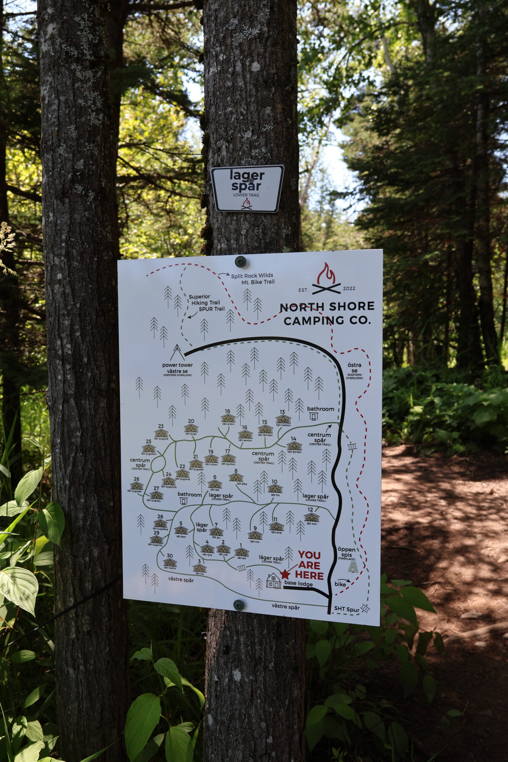 North Shore Camping Co. trail map on tree.