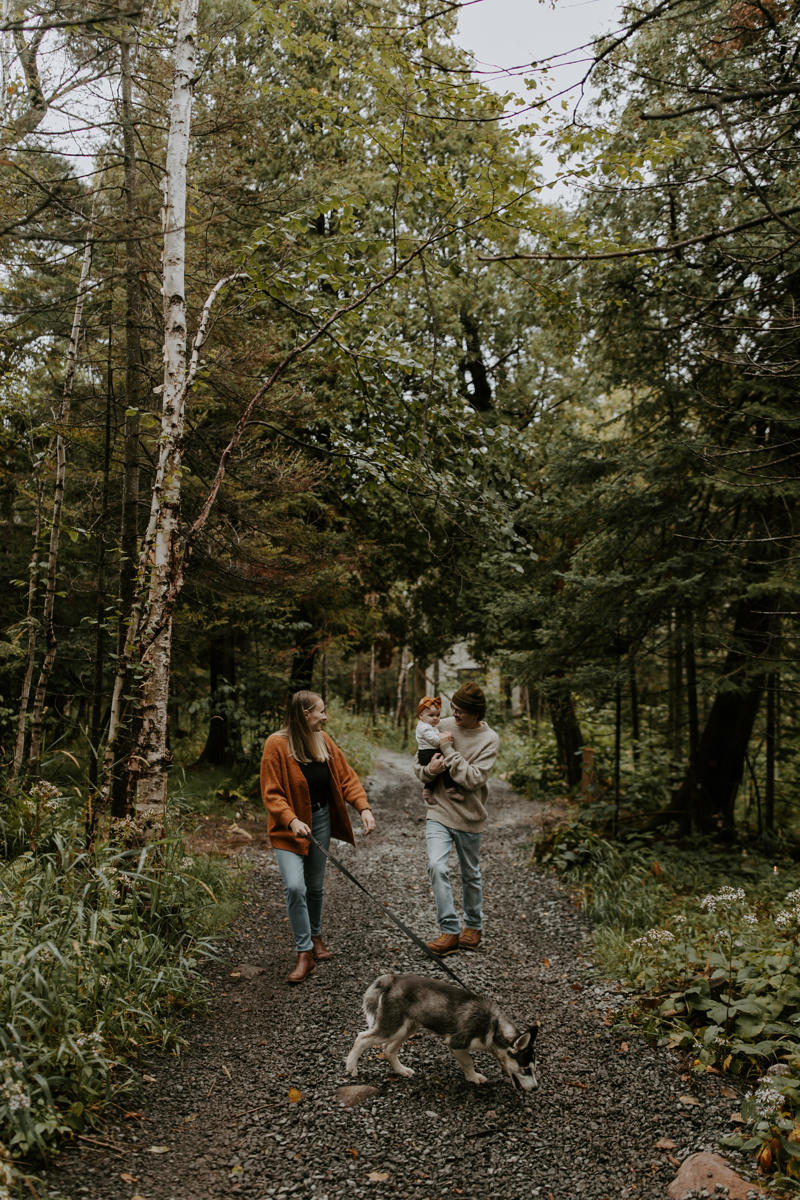 Family walking dog in forest trail